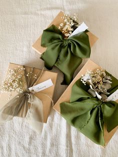 three wrapped gift boxes with flowers on them