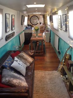 a living room filled with lots of furniture next to a clock on the side of a wall