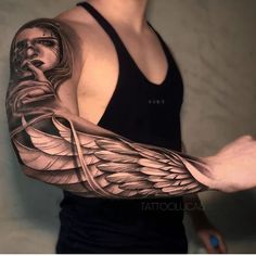 a man's arm with an angel tattoo on it