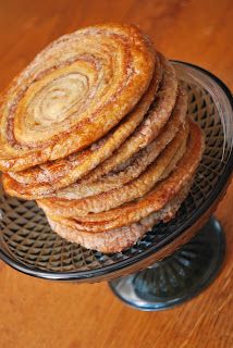 a stack of cinnamon rolls sitting on top of a metal rack