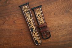 This is a 100% hand tooled watch strap with Sheridan style tooling, done on the highest quality natural veg tan in the US. Dyed oxblood with the background dyed black by hand with a fine brush. This style of tooling is a traditional western art typically done during saddle making. Lined with soft, tobacco colored veg tan pigskin. Add some traditional leatherwork to your modern Apple Watch. Available for all Apple watches in black, gold, rose gold, and matte silver. Straps are 22mm wide tapered down to 20mm. Point length is 120mm and buckle length is 80mm. If you would like custom sizing, please contact me, it should not be a problem. Please note that since the tooling is hand done, patterns may slightly vary from strap to strap. Tooled Leather Watch, Saddle Making, Leather Apple Watch Strap, Apple Watch Leather Strap, Apple Watches, Western Leather, Apple Watch Strap, Pig Skin, Western Art