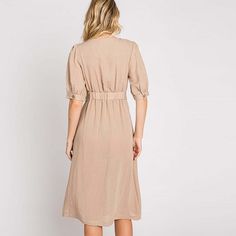 Elevate your wardrobe with our Asymmetrical Button-Down Wrapped Midi Dress, a true embodiment of timeless elegance and style. This dress offers a perfect blend of sophistication and modern flair, ensuring you'll look effortlessly chic and feel confident on any occasion. Key Features: Half-Sleeve Design: The dress features a half-sleeve with button closure, providing a touch of modesty and versatility. You can adjust the sleeves to your preference, making it suitable for various weather condition Fitted V-neck Midi Dress With Button Cuffs, Solid Color Knee-length Dress For Daywear, Classic V-neck Midi Dress With Buttons, Solid V-neck Midi Dress With Button Closure, Elegant Rayon Dresses For Daywear, Fitted Button Back Midi Dress For Work, Chic Midi Dress With Button Cuffs For Daywear, Fitted Midi Dress With Button Back For Work, Fitted Knee-length Midi Dress With Button Back