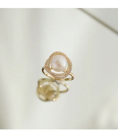 Live your vintage inspired dreams with our pearl and diamond ring. With the pearl bead in the middle and CZ Diamonds surrounding this is the perfect romantic gift for an engagement ring.• Material: High Quality 14K Gold Plated• Finish: 14K Gold Elegant Pearl Drop Diamond Ring For Anniversary, Elegant Diamond Ring With Pearl Drop For Anniversary, Elegant Gold Pearl Ring With Diamond Accents, Elegant Oval Pearl Ring With Diamond Accents, Luxury Oval Pearl Ring, Elegant Gold Halo Pearl Ring, Pearl Ring With Diamond Accents, Elegant Pearl Diamond Ring As Gift, Elegant Pearl Diamond Ring For Gift