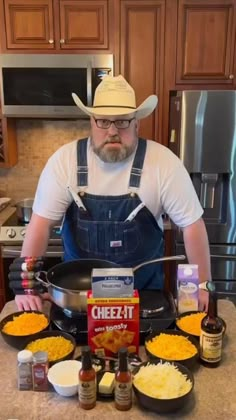 a man in overalls and cowboy hat preparing food on a kitchen counter with other ingredients