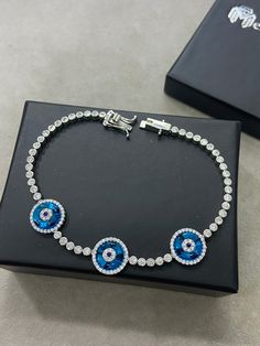 Silver Evil Eye Bracelet , Blue Stone Bracelet , Handmade Jewelry Bracelet , Good Luck Bracelet , 925K Sterling Silver Jewelry ,Gift For Him .. ★Item Details * Material : 925K Sterling Silver * Total weight : 12 Grams * Length : 18 Cm ✔ Ready to Ship in 1-2 Business Days .. ✔ Shipped to the Worldwide 1-5 business days with free shipping... ✔ The product will be sent to you with a handmade wooden box to avoid any damage during shipping... ✔ Visit our store, browse other Men's jewelry, silver and Blue Sterling Silver Bracelets, Blue Sterling Silver Round Bracelets, Blue Cubic Zirconia Sterling Silver Bracelet Gift, Adjustable Blue Round Tennis Bracelet, Adjustable Blue Tennis Bracelet, Blue Sterling Silver Jubilee Bracelet Gift, Blue Sterling Silver Evil Eye Bracelet, Blue Diamond Bracelet With Hand Set Stones, Blue Hand Set Diamond Bracelet