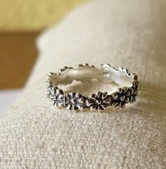 This beautiful ring with small flowers is an absolute eye-catcher. It is a highlight both individually and in combination with other stacking rings. The individual flowers are firmly soldered together, making it very stable. - Material: 925 sterling silver - Size of the flowers: approx. 4 mm - partially oxidized - solid and stable, therefore no bending If you have any questions, please send me an email and I'll get back to you, I promise. Individual Flowers, Silver Flower Ring, Ring Flower, Ring Stacking, Sterling Silver Flowers, Beautiful Ring, Flower Ring, Stacking Ring, Small Flowers