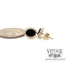 The striking color of these oval onyx stones against the golden backdrop of these earring mountings will help complete the classic wardrobe styling of a black outfit. These earrings have a filigree halo border for these bezel set onyx stones. The earrings are secured with friction post and nut in 14 karat yellow gold. Black Oval Earrings For Anniversary, Classic Black Oval Earrings, Formal Onyx Oval Cabochon Jewelry, Timeless Oval Black Enamel Jewelry, Classic Filigree Earrings, Elegant Onyx Oval Pendant Jewelry, Black Oval Earrings For Formal Occasions, Elegant Oval Cabochon Earrings For Formal Occasions, Classic Onyx Oval Cabochon Jewelry