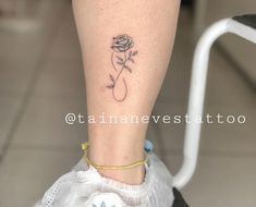 a woman's foot with a rose tattoo on her left leg and a yellow bracelet