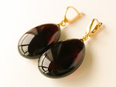 "Natural Baltic amber dark cherry/ burgundy color earrings is a perfect choice for classy style admirers! Perfect choice to brighten up office outfit or look even more beautiful on a special occasion! Shaped in drop form these earrings look delicate yet fancy. MATERIALS AND SIZE: Stone: 100% Natural Baltic Amber Findings: sterling silver 925 gold plated Weight: 8,3 g (0,29 oz) Bead size: 3 cm (1,18 in) x 2 cm (0,78 in) Total length: 4,7 cm (1,85 in) PLEASE NOTE: All our amber production is made Modern Brown Earrings For Formal Occasions, Elegant Burgundy Earrings For Formal Occasions, Elegant Tortoiseshell Drop Earrings, Classic Amber Earrings For Formal Occasions, Elegant Amber Earrings For Formal Occasions, Elegant Handmade Tortoiseshell Jewelry, Elegant Brown Drop Earrings, Modern Amber Earrings For Formal Occasions, Modern Amber Earrings For Formal Events