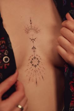 a woman's chest with an arrow tattoo on it