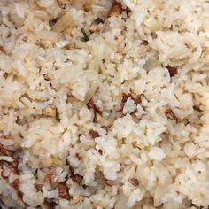 rice and meat are being cooked in a pan