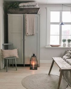 a living room with white walls and wooden floors