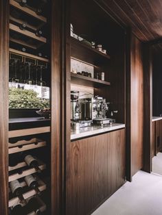 a wine cellar with lots of bottles and glasses on the shelves in front of it