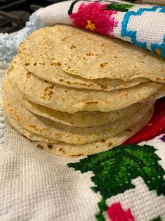 a stack of tortillas sitting on top of a blanket