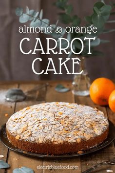 an almond and orange carrot cake on a wooden table