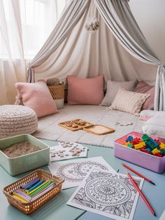 a child's room with toys and coloring books on the table