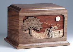 a wooden box with a horse and tree on it