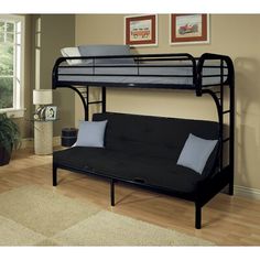 a black futon bunk bed with blue pillows on it in a living room next to a window