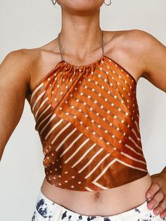 This stylish halter top is crafted from a vintage silk scarf, featuring a stainless steel chain that fastens around the neck. The lightweight design ties at the back for a comfortable, adjustable fit. Perfect for sizes XS to S. Silk Halter Neck Top For Summer, Silk Halter Neck Top, Sleeveless Silk Halter Top For Summer, 70s Scarf Top, Silk Scarf Halter Top, Scarf Halter Top, Vintage Silk Scarf, Scarf Top, Halter Tops