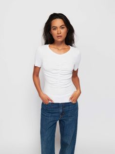 May attract attention. (The good kind.) It's the short sleeve tee you live in, but with a raw hem and a gathered seam down the front. (This one comes in White.) | Women's Nevina Tee Top in White | Ethical Essentials Fitted White Tops For Casual, Fitted White Top For Casual Gatherings, White Fitted Top For Casual Gatherings, Short Sleeve Tops For Casual Gatherings With Relaxed Fit, Fitted T-shirt For Casual Gatherings, Spring Fitted T-shirt For Casual Gatherings, Spring Fitted T-shirt For Casual Wear, Fitted T-shirt For Casual Spring Gatherings, Spring Casual Fitted T-shirt