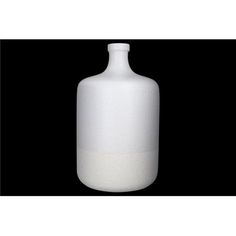 a white vase sitting on top of a black background