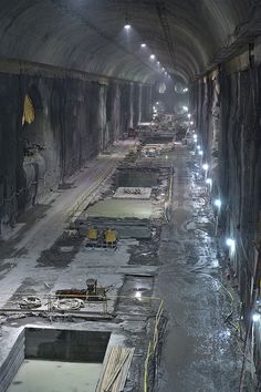 an underground tunnel filled with lots of construction equipment