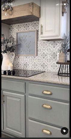 a kitchen with white cabinets and gray counter tops, decorated for the holiday season or christmas