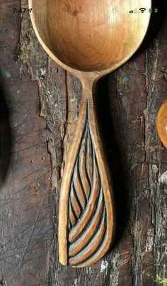 a wooden spoon sitting on top of a piece of wood