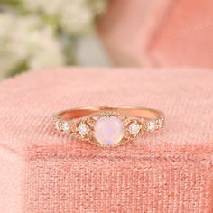 Vintage Ethiopian Opal Engagement Ring, Genuine Fire Opal Ring, Opal Cabochon Promise Ring, Antique Opal Anniversary Ring, Art Deco Rings ✧･ﾟ: *✧･ﾟ:* Welcome to Charles Davin Jewelry*:･ﾟ･ﾟ✧ Moissanite - a gemstone known to bring in luck in someone's life, the user can give off a look of elegance. You can give your special someone luck whilst showing your love to them. ✶Material: 10K/ 14K/ 18K ✶Main Stone: Natural Ethiopian Opal; approx. 5.0mm ✶Side Stone: Moissanite; Total approx. 0.2ct ✶Color: Round Cabochon Opal Anniversary Ring, Cabochon Opal Ring For Anniversary, Round Cabochon Opal Ring For Anniversary, White Gold Opal Ring With Bezel Setting For Anniversary, Wedding Fine Jewelry With Cabochon, Cabochon Fine Jewelry For Weddings, Fine Jewelry Opal Diamond Ring, Round Opal Diamond Ring In Fine Jewelry Style, Fine Jewelry Cabochon Moonstone Ring For Anniversary