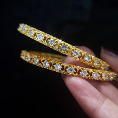 "* Handcrafted Gold Plated Bangle Set * High Quality 22 K Gold Plated 2 pc bangle set; * Available Sizes: 2.4 ( 2.30\" diameter of the inner circle) ; 2.6 ( 2.43\" inner circle diameter); 2.8 (2.54\" diameter of the inner circle) * Sold as a set of 2 bangles The gorgeous gold-plated bangle/ bracelet best exemplifies the careful craftsmanship done on it -- a specialty at Nemali Jewelry. It has a special tone of elegance attached to it. The intricate handmade design of the bangle/bracelet set give Dazzling Hoop Jewelry For Wedding, Hoop Bangle For Wedding, Stackable Hoop Jewelry For Wedding, Stackable Hoop Wedding Jewelry, Adjustable Hoop Style Bangle For Wedding, Dazzling Round Bangle As A Gift, Dazzling Round Bangle Gift, White Bangle Jewelry For Marriage, Stackable Bangle Jewelry For Wedding