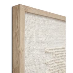 a close up of a wooden frame with white fabric on it