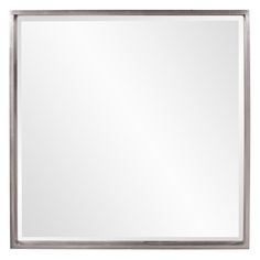 a large silver framed mirror on a white wall with an empty space for the reflection