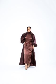 The Organza Abaya is statement outfit for any event. It's super lightweight yet so simple with the prettiest sheen. Complete the look with our matching long sleeve satin slip dress and a pair of strappy heels for a luxe finish or make it into a more casual look. *Please note that the color displayed in the picture might be slightly different due to the color resolution and lighting. Fabric Description & Care: Balloon Sleeves with elastic cuff Double Lined Material: Silk/Organza Dry Clean for bes Elegant Satin Abaya For Party, Evening Satin Maxi Abaya, Evening Satin Maxi-length Abaya, Elegant Satin Maxi Abaya, Silk Maxi Abaya For Party, Elegant Silk Maxi Abaya, Elegant Long Sleeve Satin Abaya, Silk Long Abaya For Party, Silk Abaya For Eid Party