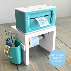 a blue and white printer sitting on top of a wooden table