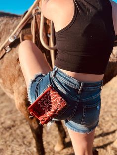 Giddy up in style with our Giddy Up Embroidered Bandana! This vintage-inspired bandana features a vintage red, black & white paisley print, accented by playful "Giddy Up" black stitching embroidery. Perfect for adding a touch of western flair to any outfit. Yeehaw!