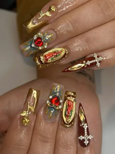 some very pretty nails with gold and red designs on them