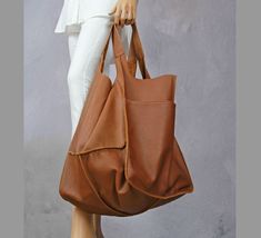 "Oversized carryall handbag, Leather tote bag with pocket, Giant oversize tote bags, Carryall shopper bag soft leather, Camel brown tote This oversized bag has been carefully designed to be the perfect everyday bag. The size makes it practical for carrying everyday essentials. Made from 100 percent Italian leather. This bag is available in different colors, check in my store.   * Includes two large internal pockets for mobile phone and other small items. * Top closure magnet for security. Height: 39 cm / 15.3\" Height from top of handle to base: 68 cm / 26.8\" Handle drop: 26 cm / 10.2\" Width: 34 - 74 cm / 13.4\" - 29.1\" Depth: 28 cm / 11\" The leather of this product has been produced in an audited and certified tannery in Italy.    To return to my shop, simply click here: https://www.e Brown Hobo Bag With Pockets For Shopping, Large Beige Satchel With Large Capacity, Chic Brown Hobo Bag With Pockets, Shopping Tote Shoulder Bag With Pockets, Hobo Bag With Pockets And Double Handle For Shopping, Large Capacity Tote Weekender Bag For Shopping, Double Handle Hobo Bag With Pockets For Shopping, Chic Hobo Bag With Double Handle And Pockets, Brown Large Capacity Satchel For Errands