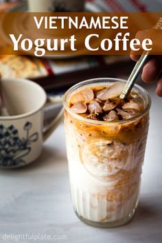 vietnamese yogurt coffee in a glass with ice and toppings on the side