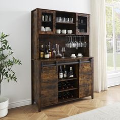 a wooden cabinet filled with wine glasses and bottles