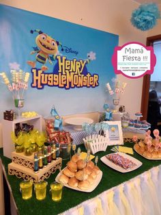 the table is set up for a very cute monster birthday party with desserts and snacks