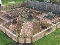 an outdoor garden area with brick pavers and trellis fenced in to it