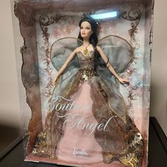 a barbie doll in a box with an angel on it's head and wings