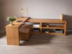 a wooden desk with shelves and vases on it