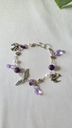 Lilac Charm Bracelet is made from amethyst beads, amethyst chips, glass beads, pewter charms, and tarnish-resistant silver plated copper wire. Everything is handmade by me ♡  Feel free to send me a message if you want custom sizing Let me know your ring size for accurate sizing on free gift! Amethyst Beads, Cute Bracelets, Hand Jewelry, Star Charms, Cute Jewelry, Copper Wire, Charm Bracelets, Beaded Jewelry, Lilac