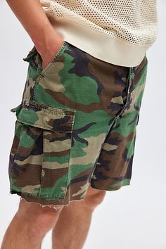 Remade camo cargo shorts by Urban Renewal. Classic camo shorts with a raw cut hem for a one-of-a-kind style. Though similar in style to what you see here, each upcycled item will vary from piece to piece. Features Urban Renewal Remade camo short Cargo pocket shorts Allover camouflage pattern Raw cut hem Made using upcycled materials Each pair is unique Content + Care Machine wash Imported Size + Fit Model is 6’2" and wearing size Medium | Urban Renewal Remade Camo Short in Green Camo, Men's at Urban Outfitters Outdoor Camouflage Shorts, Camouflage Short Sleeve T-shirt For Streetwear, Camo Cargo Shorts, Military Camouflage Shorts For Streetwear, Short Cargo, Camouflage Shorts, Military Camouflage Cargo Shorts For Outdoor, Men's Shoes Accessories, Military Camouflage Cotton Shorts