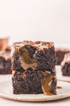 two brownies stacked on top of each other with caramel drizzle