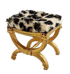 an animal print stool with gold legs and a fur cover on it's top