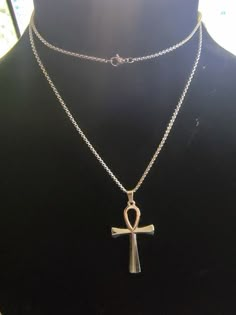 This stunning Ankh Pendant Necklace is the perfect accessory for anyone looking to add some style and symbolism to their wardrobe! The pendant stands tall at 2 inches and is crafted from sturdy polished stainless steel, ensuring durability and a high-quality look. It hangs beautifully on a 28 inch metal necklace, making it a versatile piece that can be worn for any occasion. Elevate your style with this meaningful and long-lasting piece of jewelry. Ankh Cross Necklace, Ankh Jewelry Necklaces, Ankh Pendant, Ankh Necklace, Ankh Cross, Metal Necklace, Necklace Making, Polished Stainless Steel, Stand Tall