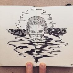 a drawing of a woman's face in the water