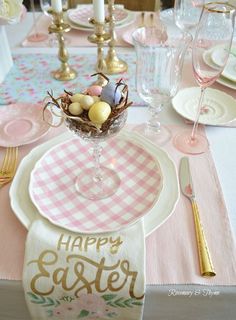 an easter table setting with pink and white napkins